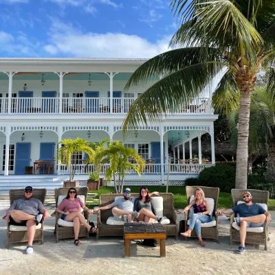 a group of people sitting on a bench in front of a building