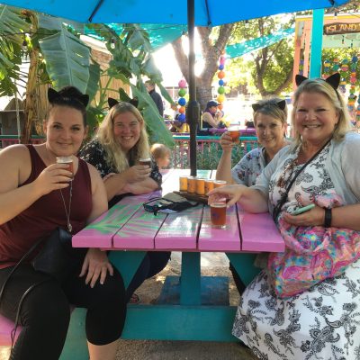 a group of people sitting on a bench posing for the camera