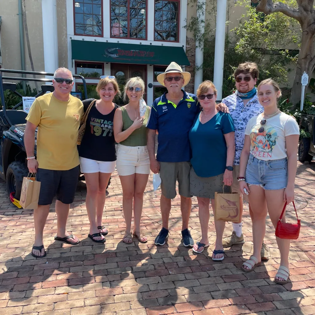 a group of people standing in front of a crowd posing for the camera