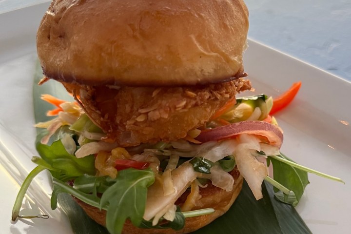 a close up of a lobster slider sandwich on a plate