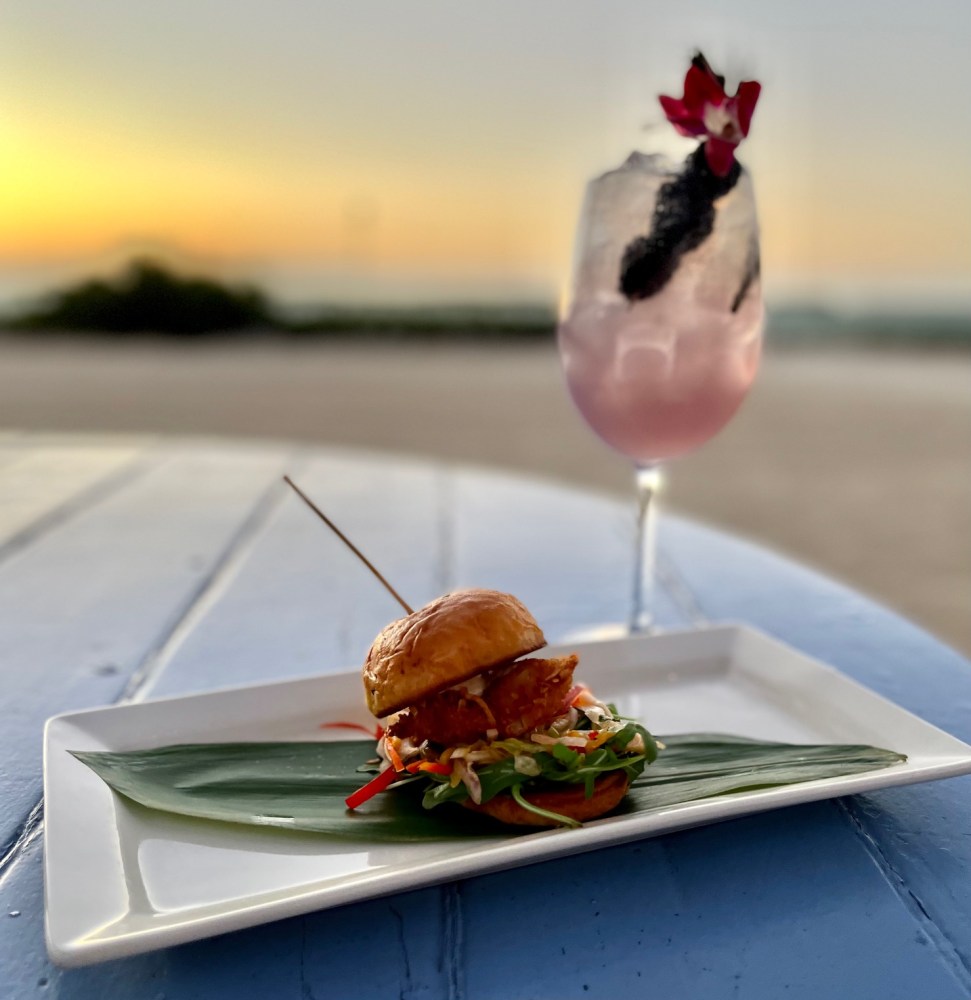 a close up of a plate of food with a glass of wine