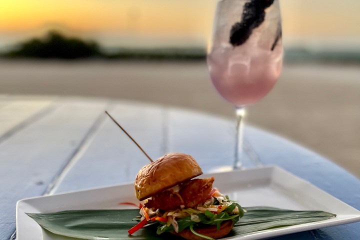 a close up of a plate of food with a glass of wine