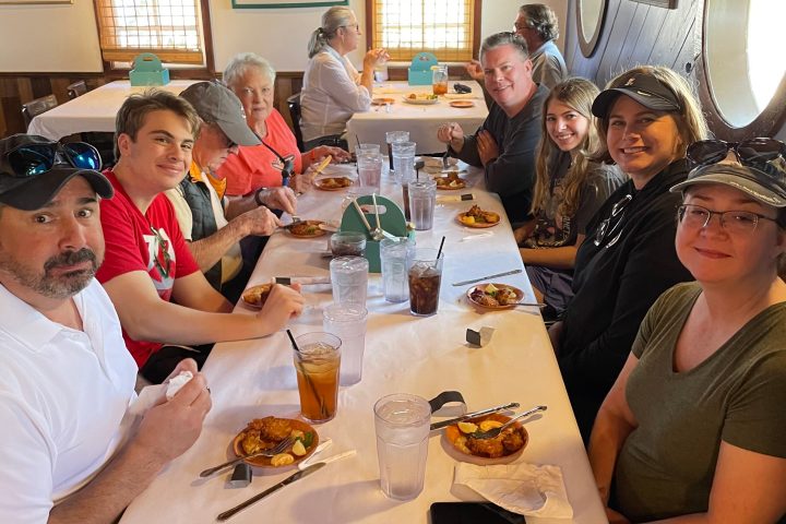 a group of people sitting at a dinner table