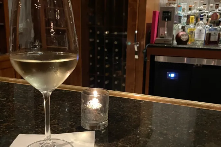 a glass of wine sitting on top of a counter