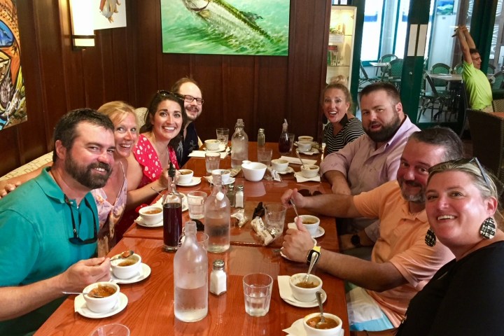 a group of people sitting at a table in a restaurant