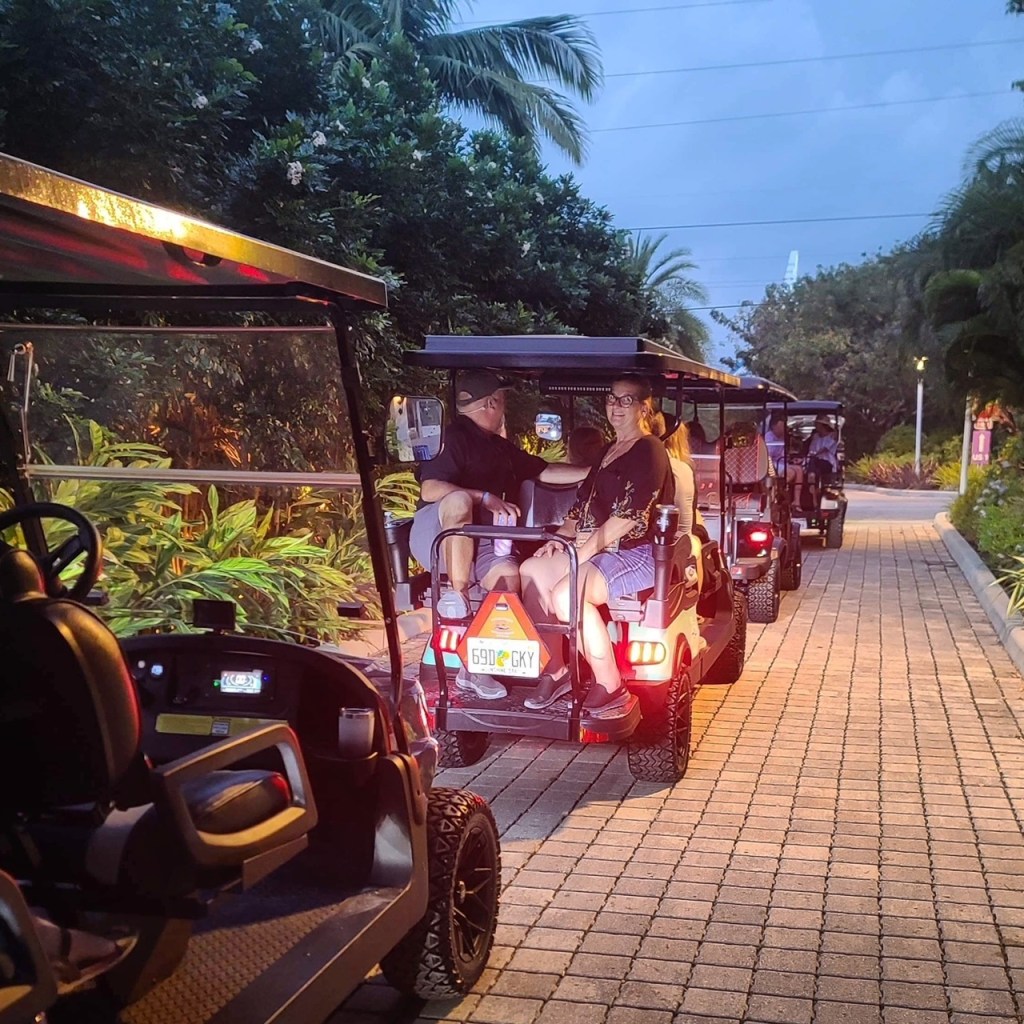 a group of people riding on the back of a golf cart for a food tour in islamorada florida keys