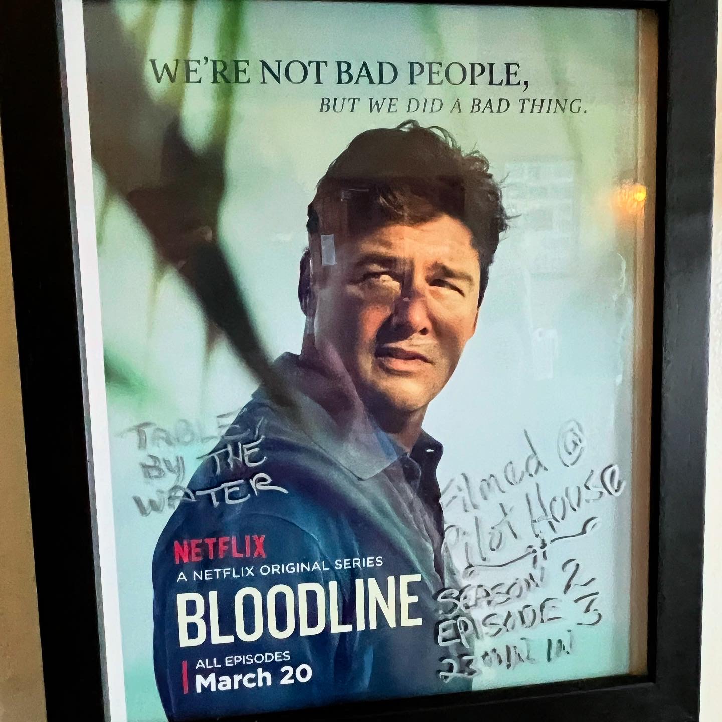 Poster for Netflix's 'Bloodline' series with a man's face and text: 'We're not bad people, but we did a bad thing.' from Pilot House Florida Keys
