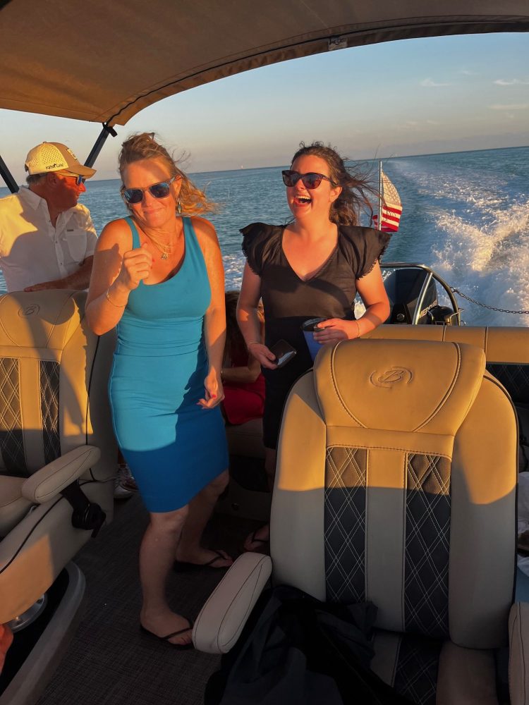 Two women smiling on the poppa toon moves over the Florida Bay waters in Ilsamorada