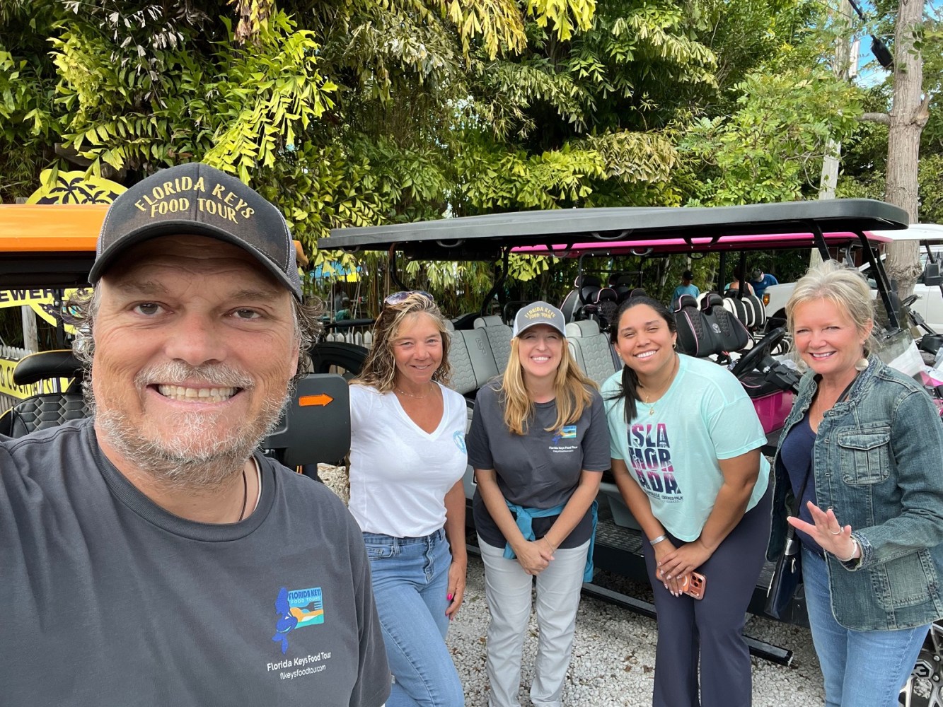 Our five guides and golf cart drivers smiling in front of their islamorada luxury golfs at the Islamorada Brewery